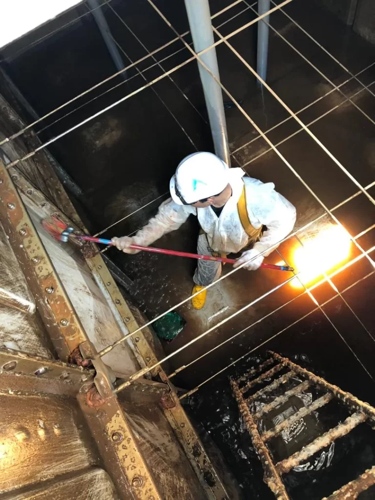 man cleaning the interior of water tank